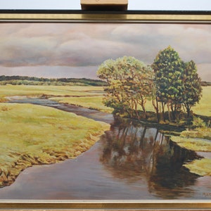 May include: A painting of a river winding through a field with trees on the banks. The sky is cloudy and the water is reflecting the trees. The painting is signed "Matthews 1957" in the lower right corner.
