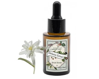 May include: A brown glass bottle with a black dropper, labeled "Edelweiss Extract Serum booster." A white edelweiss flower is next to the bottle. The bottle contains 0.3oz/10ml of serum.