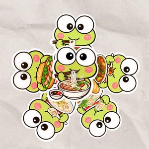 May include: A collection of five cartoon frog stickers arranged in a circular pattern. Each green frog with large white eyes is depicted eating different foods, including a bowl of noodle soup, a sandwich, a stew, and fresh spring rolls.