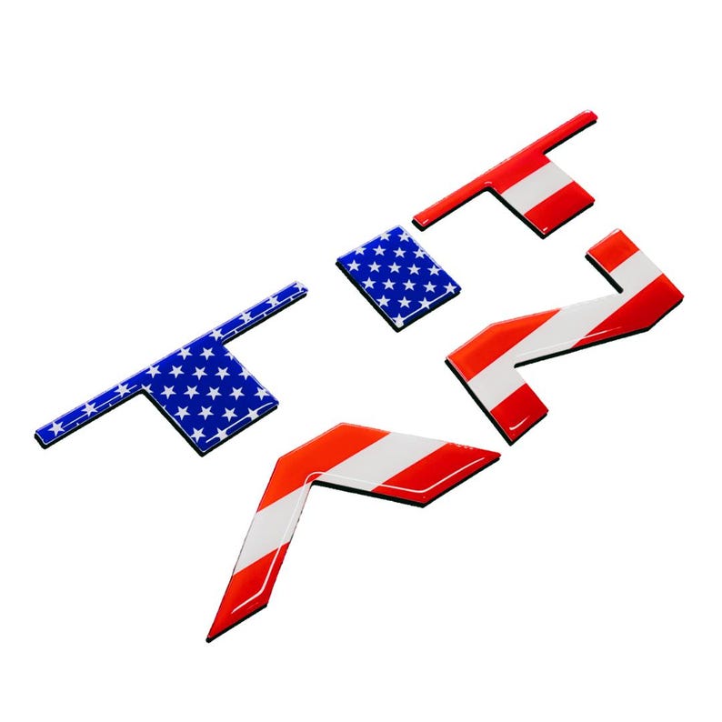 May include: Three dimensional letters spelling "TRF" with a red, white and blue American flag design.