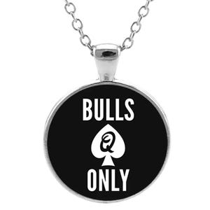 May include: A black and white necklace with a round pendant that says "BULLS Q ONLY" in white text on a black background.