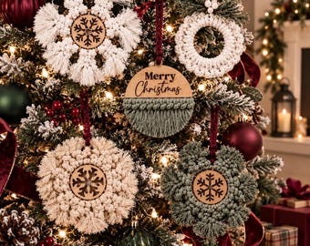 May include: A collection of five macrame Christmas ornaments featuring cream and sage green knotted cord designs. Four ornaments have circular wooden centers with laser-cut snowflake patterns, and one features the text Merry Christmas.