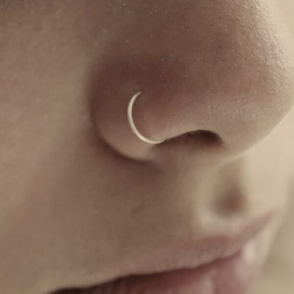 Discreet titanium nose ring piercing, thin titanium nostril ring piercing