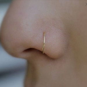 Gold nose ring piercing, gold nostril piercing