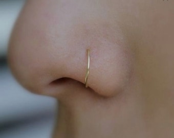 Golden nose ring piercing, golden nostril piercing