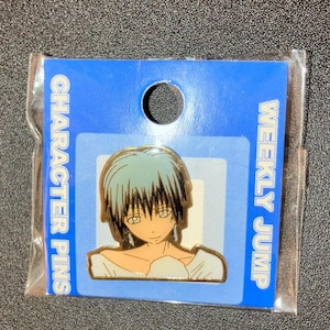May include: A pin featuring an anime character with blue hair and a white shirt. The pin is on a blue backing card that reads "CHARACTER PINS" and "WEEKLY JUMP". The pin is packaged in a clear plastic sleeve.