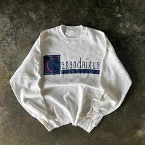 May include: A set of three ceramic mugs with a speckled, matte finish. The mugs are in shades of cream, light gray, and dark gray. Each mug has a simple, minimalist design, perfect for coffee or tea.