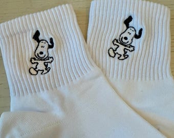 Ladies quarter crew socks embroidered with Charlie Brown's lovable dog, Snoopy from the Peanuts gang.