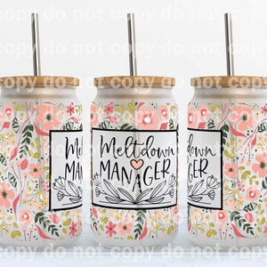 May include: A set of three glass tumblers with floral patterns and bamboo lids. Each tumbler has a stainless steel straw and a label that reads "Meltdown MANAGER" in black script with a heart. The floral design includes pink and peach flowers.