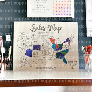 May include: Wooden sales map of the United States with state outlines and the text "Sales Map One State at a Time." Several states are colored in blue, red, green, and purple. The website address "PUTTINONTHEPRINTZ.NET" is visible.