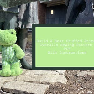 May include: A green frog stuffed animal wearing a green and white checkered overall. The frog is standing on a stone path. The text on the image reads "Build A Bear Stuffed Animal Overalls Sewing Pattern PDF With Instructions".