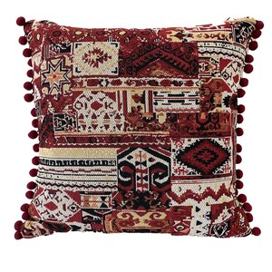 Burgundy cushion cover in kilim-style patchwork with pom poms