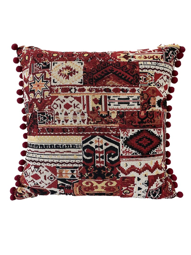 Burgundy cushion cover in kilim-style patchwork with pom poms