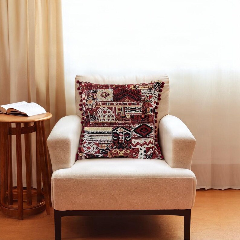 Burgundy cushion covers: the patchwork kilim cushion on a cream armchair by a side table