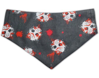 May include: Gray dog bandana with a white and red print of a hockey mask with blood splatters.