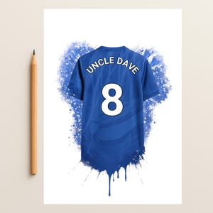 May include: A blue sports jersey featuring the text UNCLE DAVE and the number 8 in white. The design includes a blue watercolor splash effect behind the jersey. A wooden pencil is positioned vertically to the left of the jersey for scale.