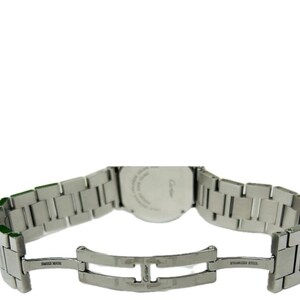 May include: A stainless steel Cartier watch with a silver band. The watch band is open, revealing the clasp and the words "SWISS MADE" and "STAINLESS STEEL". The watch face is visible, with the Cartier logo.