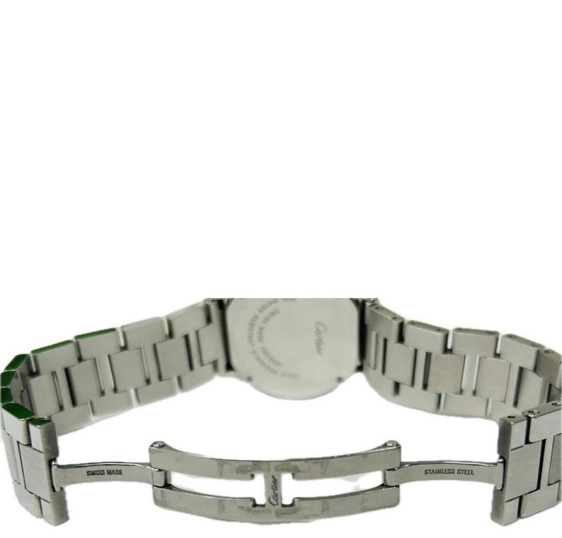 May include: A stainless steel Cartier watch with a silver band. The watch band is open, revealing the clasp and the words "SWISS MADE" and "STAINLESS STEEL". The watch face is visible, with the Cartier logo.