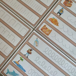 May include: A set of printable tracing worksheets for kids featuring pirate-themed illustrations. The worksheets include tracing lines, shapes, and letters. The illustrations include a treasure chest, a pirate, a bottle, an island, and a shark.