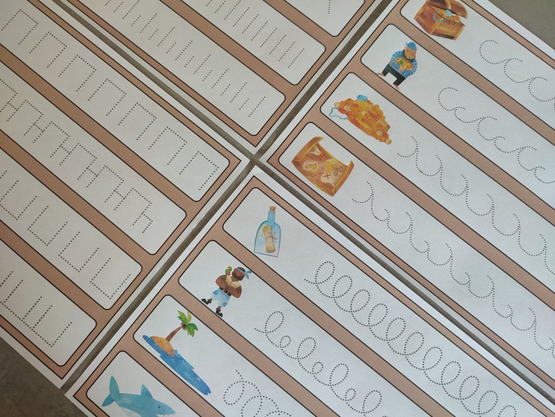 May include: A set of printable tracing worksheets for kids featuring pirate-themed illustrations. The worksheets include tracing lines, shapes, and letters. The illustrations include a treasure chest, a pirate, a bottle, an island, and a shark.