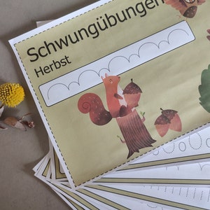 May include: A set of printable worksheets for kids to practice their handwriting skills. The worksheets feature a squirrel holding acorns and the word "Schwing&uuml;bungen Herbst" which translates to "Swing Exercises Autumn".