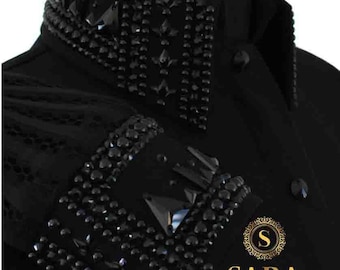 May include: Black long-sleeve shirt with a black rhinestone design on the collar and cuffs. The shirt has a small gold logo with the letter "S" and the word "SARA" below it.