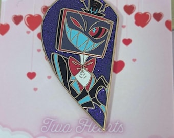 May include: A purple and blue glitter heart-shaped enamel pin featuring a cartoon character with a television screen for a head. The character is wearing a black suit, a red bow tie, and a top hat. The pin says "Two Hearts" at the bottom.