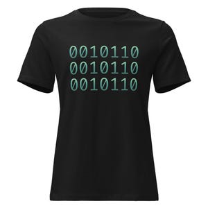 May include: Black t-shirt with the binary code "0010110" printed three times in a teal gradient. The shirt is a crew neck style and appears to be made of a soft material.