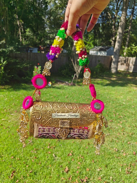 Embossed Brass Potli Bag: Pompom Strap, Coin Accents