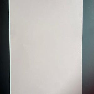 May include: A plain, light pink sheet of paper.