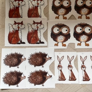 Può includere: Un set di sagome di animali stampabili che includono una volpe, un gufo, un riccio e un coniglio. Gli animali sono illustrati in uno stile cartone animato con occhi grandi e pelliccia marrone e bianca.