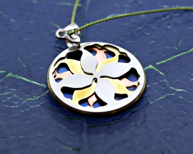 Large leaf mandala necklace in blue, orange, yellow, and silver tones.