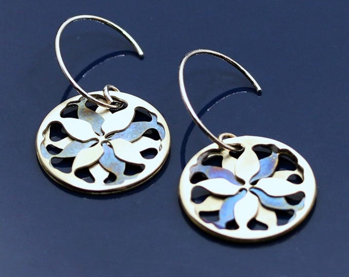 Blue and silver round hoop earrings adorned with a refined abstract floral motif.