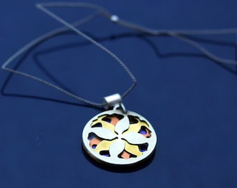 Small leaf mandala necklace in shades of blue, yellow, orange, and silver.