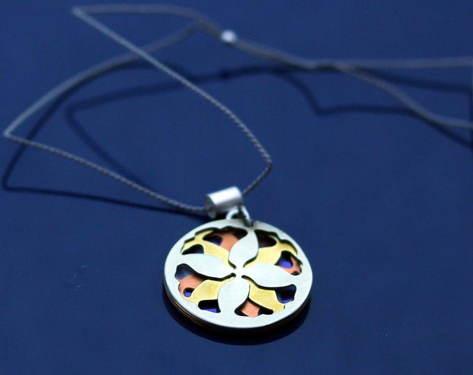 Small leaf mandala necklace in shades of blue, yellow, orange, and silver.