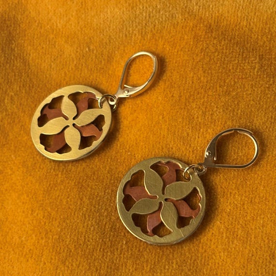 Round hoop earrings with a lovely abstract floral ornament.