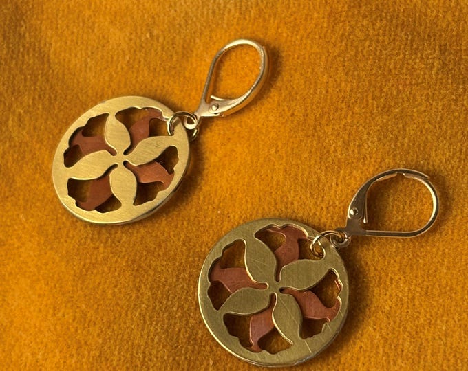 Abstract floral hoop earrings in copper and brass, lightweight design.