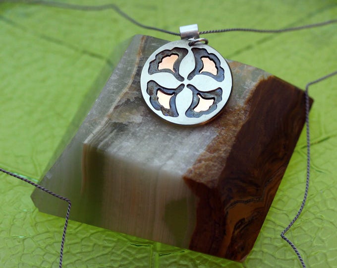 Ginkgo leaf necklace in shades of blue, warm copper, and silver.