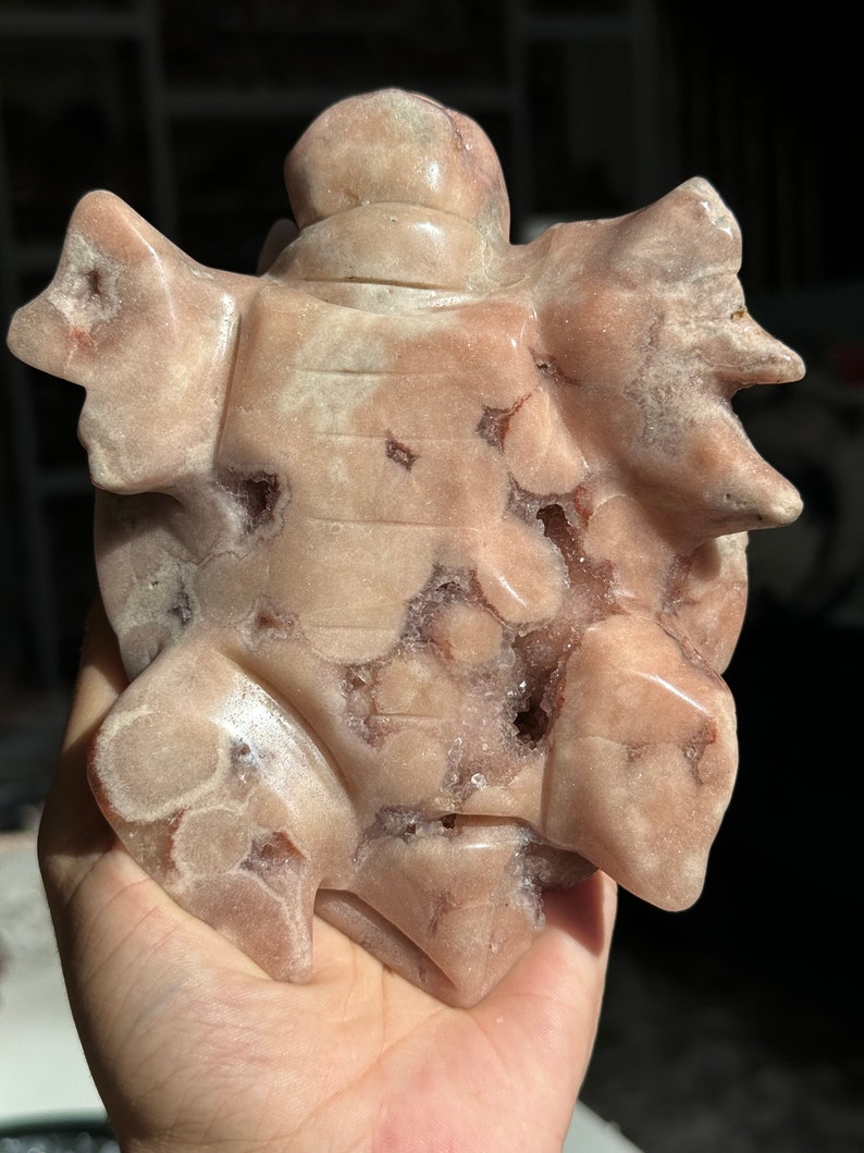 May include: A pink and white carved turtle figurine made of a natural stone with a unique, textured surface.