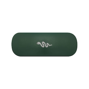 May include: A dark forest green, oblong-shaped hard case with rounded ends. Centred on the top surface is a small, detailed silver-toned emblem of a snake in a winding, horizontal position with a textured, dotted pattern on its body.