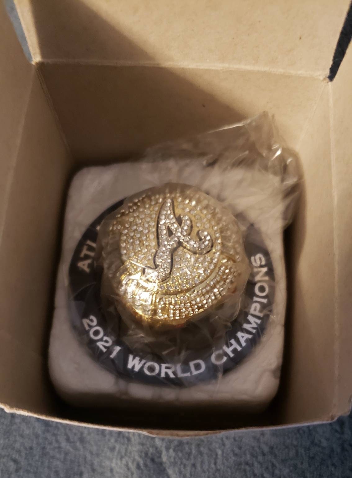 An Atlanta Braves fan shows off a replica World Series ring that