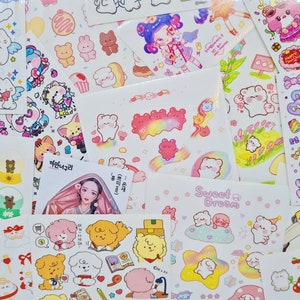 May include: Assortment of colorful stickers featuring cute cartoon characters, animals, and designs. The stickers are on white sheets with various text in Korean and English, including "Waterball", "Sweet Dream", and "Peach Cherry".