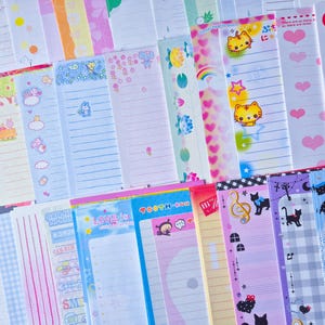 Puede incluir: Una colecci&oacute;n de blocs de notas coloridos y estampados. Los dise&ntilde;os incluyen gatos de dibujos animados, corazones, arco&iacute;ris y otras ilustraciones bonitas. Algunos blocs tienen p&aacute;ginas rayadas, otros est&aacute;n en blanco.