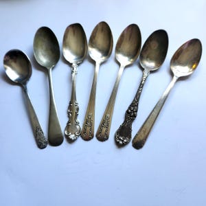 Set of 7 mixed vintage spoons with unique designs for décor or crafting