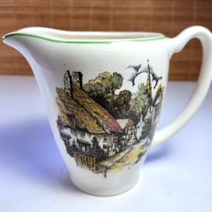 May include: A distressed wooden sign, reading "Welcome to our home" in white lettering. The sign has a rustic finish, ideal for a front porch or hallway, creating a welcoming atmosphere.