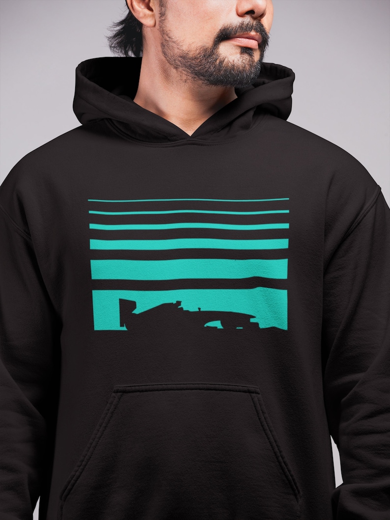 May include: Black hooded sweatshirt with a teal blue graphic of a race car on a striped background.