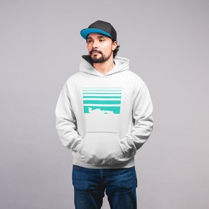 May include: A white hooded sweatshirt with a teal and white graphic design. The graphic features a series of horizontal lines and a stylized image of a car.