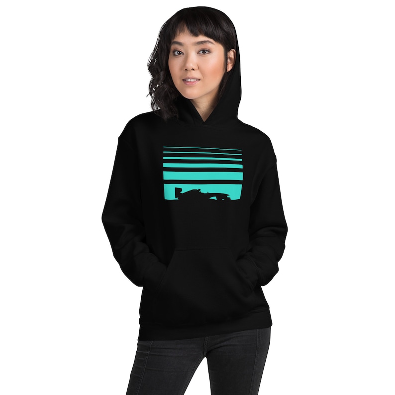 May include: Black hooded sweatshirt with a turquoise graphic of a race car silhouette against a striped background.
