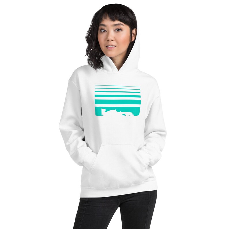 May include: White hooded sweatshirt with a teal blue graphic of a race car on a striped background.