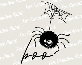 May include: A black and white illustration of a spider with a web above it. The spider has a fuzzy body and a smiling face. The text "Boo" is written below the spider.